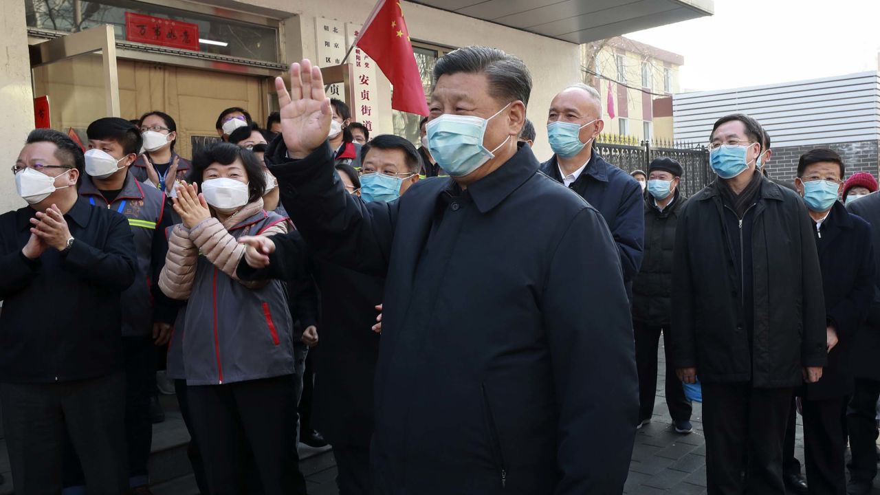 In this photo released by Xinhua News Agency, Chinese President Xi Jinping, centre, wearing a protective face mask waves as he inspects the novel coronavirus pneumonia prevention and control work at a neighbourhoods in Beijing, Monday, Feb. 10, 2020. China reported a rise in new virus cases on Monday, possibly denting optimism that its disease control measures like isolating major cities might be working, while Japan reported dozens of new cases aboard a quarantined cruise ship. (Pang Xinglei/Xinhua via AP)