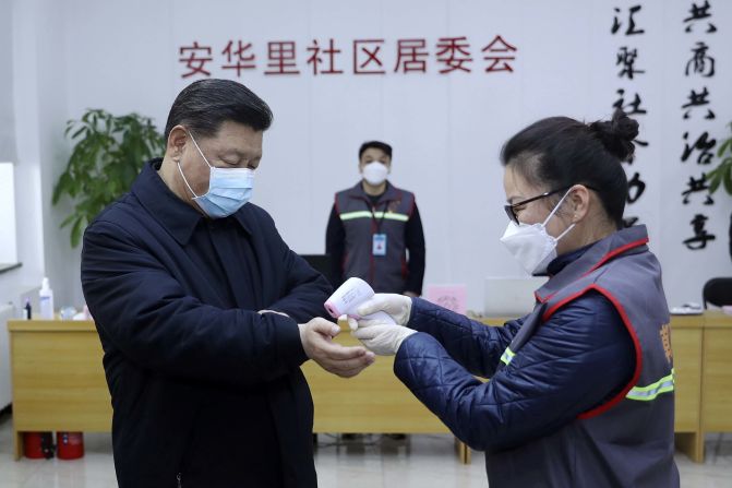 Chinese President Xi Jinping has his temperature checked during an appearance in Beijing on February 10, 2020.
