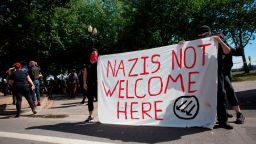 Antifa hold up a sign along a road denouncing Nazis during a protest to oppose the right wing group "The Patriot Prayer Movement," that was having a rally in downtown Portland, Oregon on September 10, 2017. 
