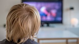 Stock photo of a child watching TV. 