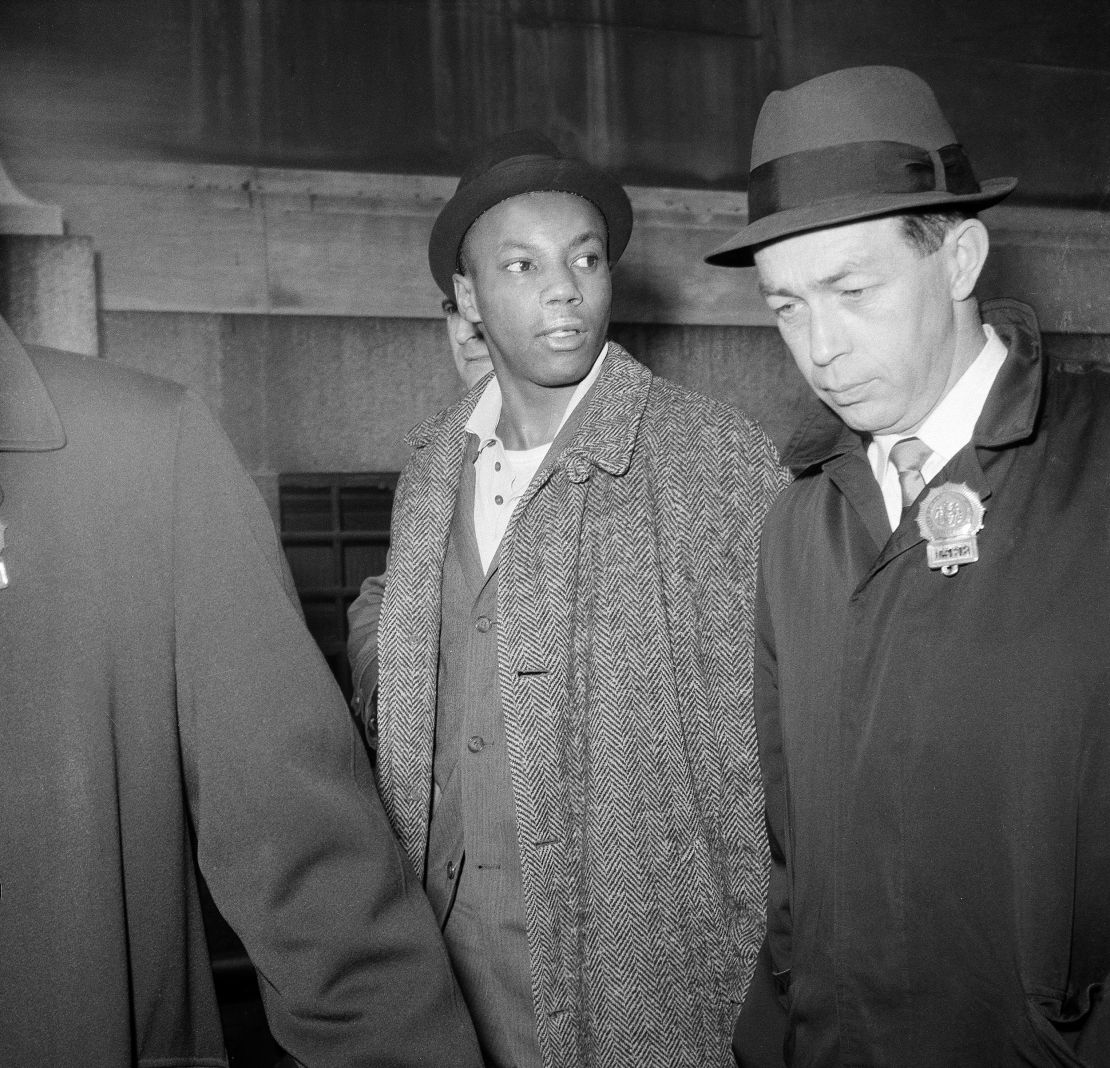 Norman 3X Butler is escorted by police after his arrest in New York on February 26, 1965.