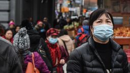A pedestrian wearing a face mask walks along a street in the Flushing neighborhood in the Queens Borough of New York, U.S., on Wednesday, Feb. 5, 2020. Just a couple of weeks ago, scientists held out hope the new coronavirus could be largely contained within China. Now they know its spread can be minimized at best, and governments are planning for the worst. Photographer: Stephanie Keith/Bloomberg via Getty Images