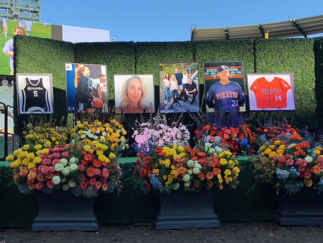 The makeshift shrine to John Altobelli, his wife, Keri, and their daughter Alyssa is adorned with poster-sized photos and flowers. 