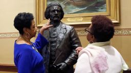 Joyce Amos, left, and Pamela Johnson, who both work in the office of Maryland House Speaker Adrienne Jones, inspect a bronze statue of abolitionist Frederick Douglass during a private viewing ahead of its unveiling at the Maryland State House, Monday, Feb. 10, 2020, in Annapolis, Md. The statue, along with a statue of Harriet Tubman, will be unveiled Monday night in the Old House Chamber, the room where slavery was abolished in Maryland in 1864.