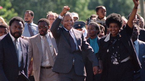 Nelson Mandela and his wife Winnie salute a cheering crowd upon his release from prison on February 11, 1990.