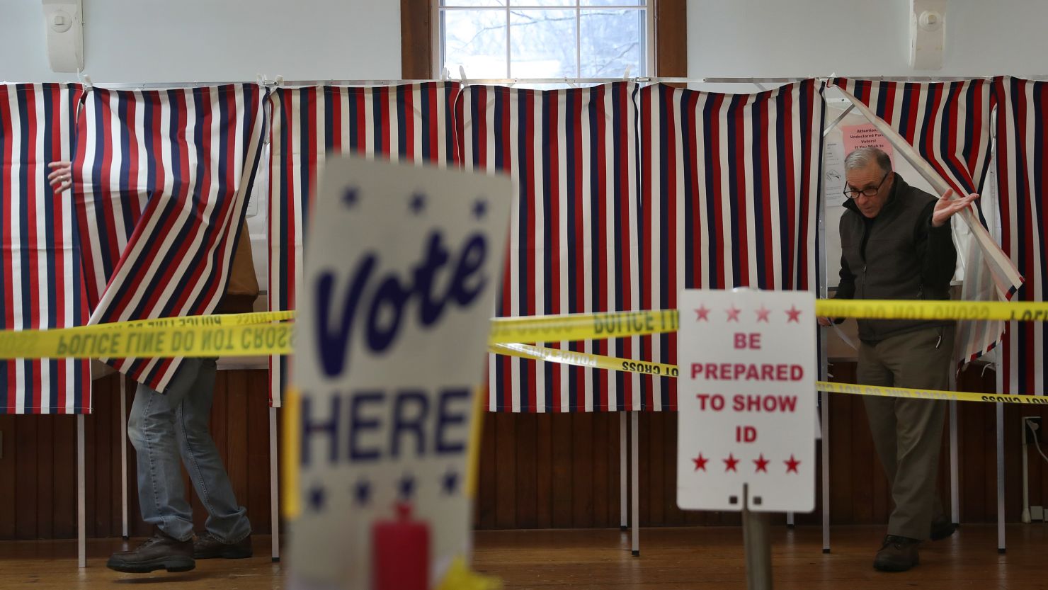 Voters emerge from polling booths setup at the Chichester Town Hall, New Hampshire, in February 2020.