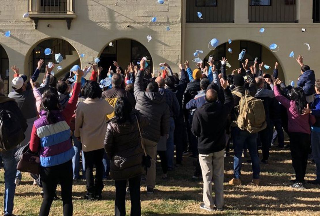 American evacuees from Wuhan toss their face masks as they end their 14-day coronavirus quarantine Tuesday at March Air Reserve Base in California.