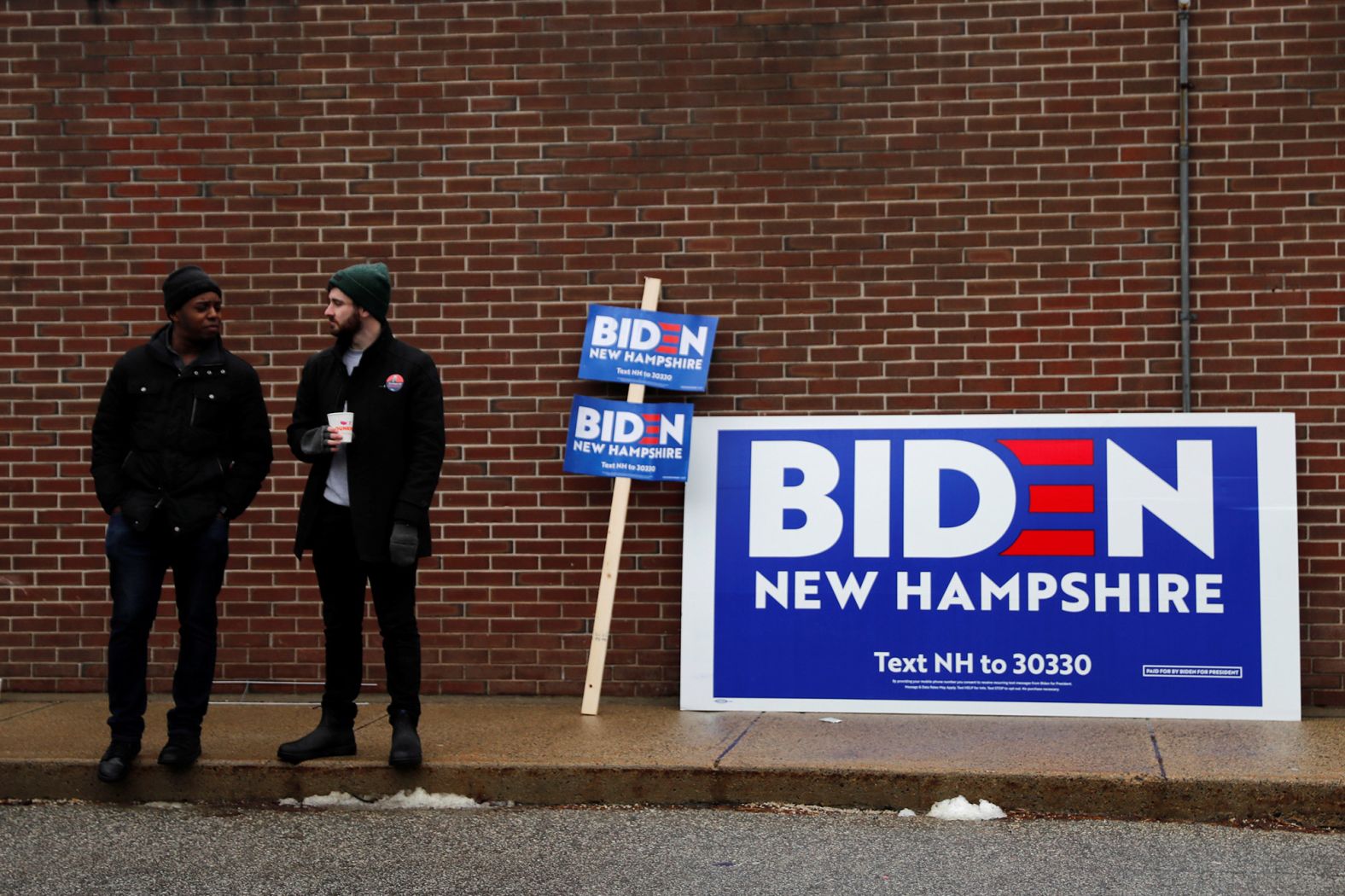 Biden supporters stand outside a polling station in Manchester on February 11.
