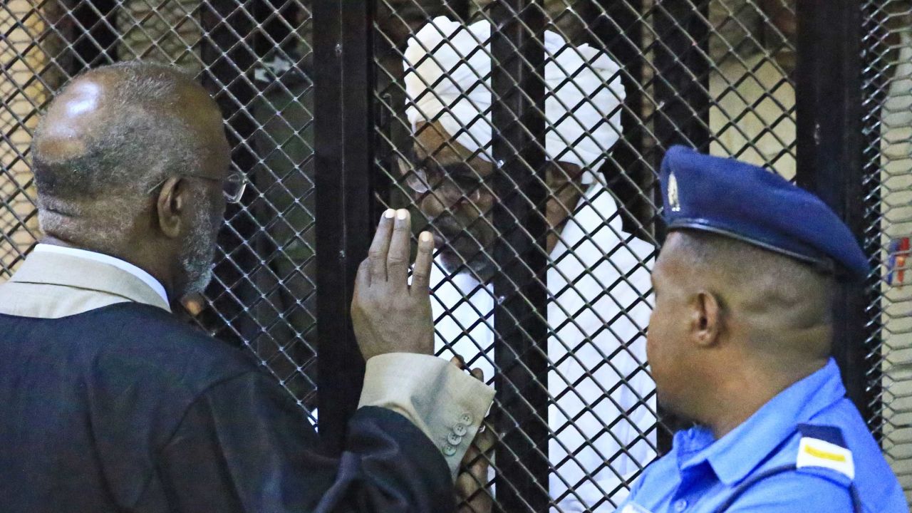 Sudan's deposed military president Omar al-Bashir in a defendant's cage during his corruption trial at a court in Khartoum on December 14, 2019.