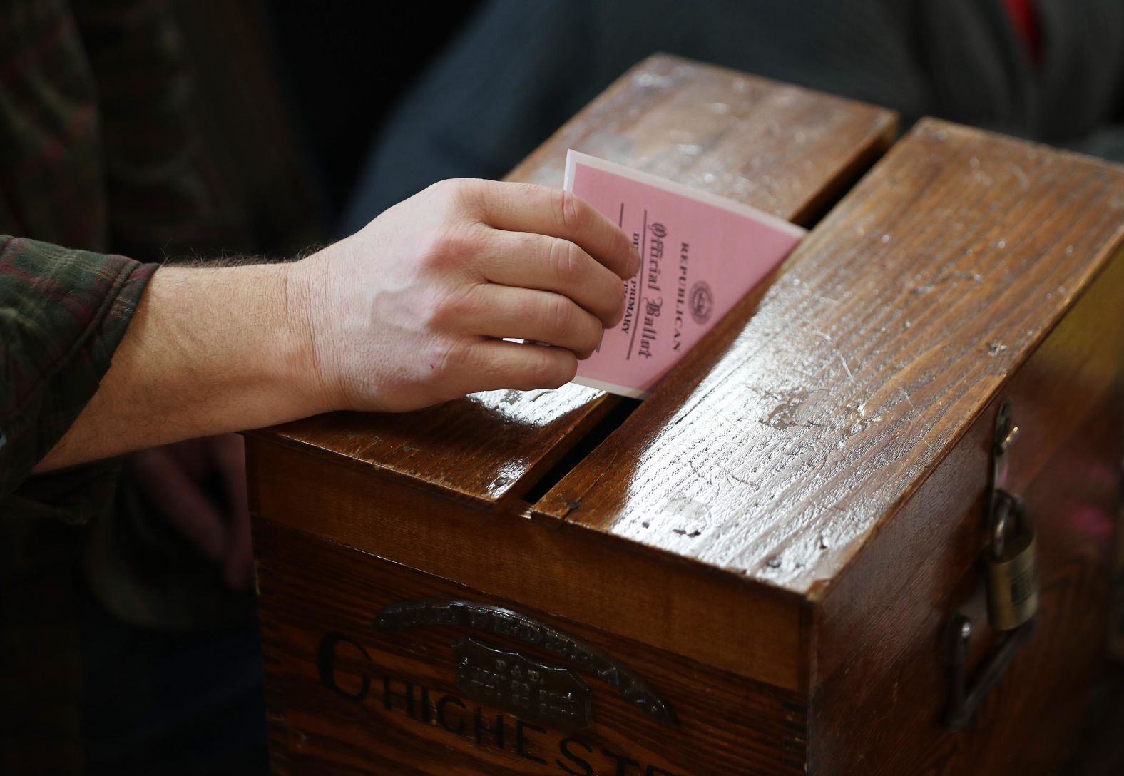 A voter drops a ballot in Chichester on February 11.