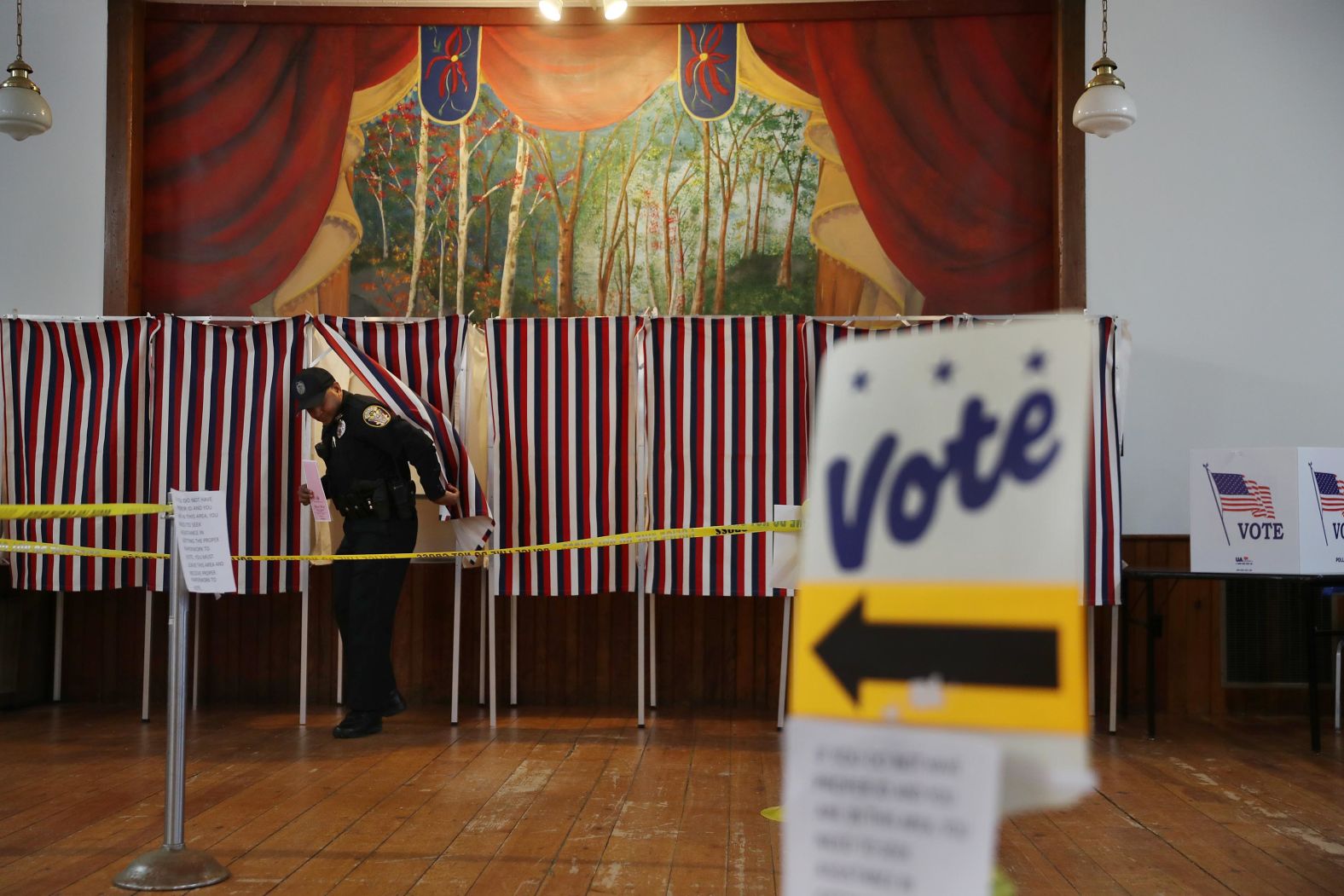 Police officer Ian Berkeley emerges from a voting booth after voting in Chichester, New Hampshire, on February 11.