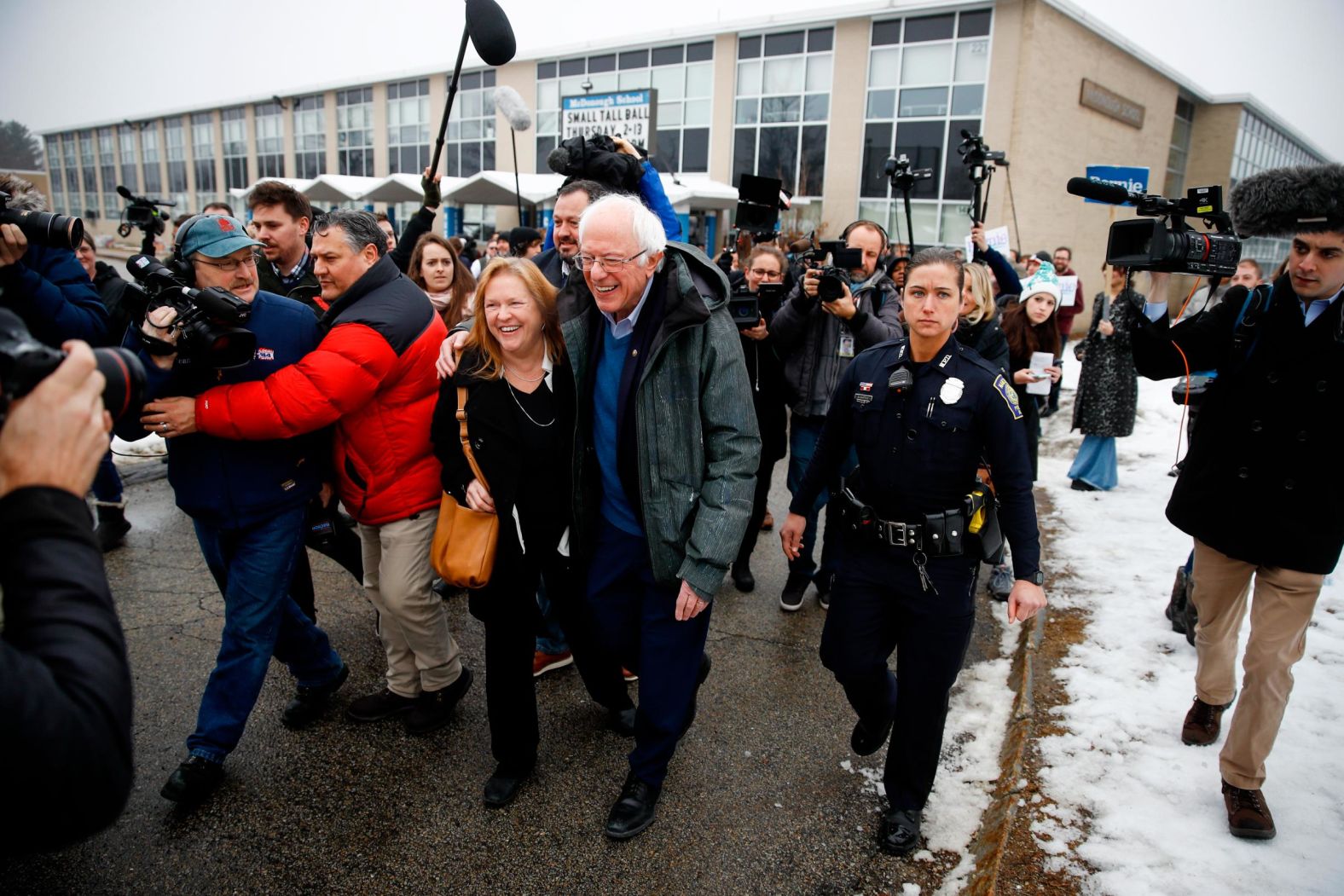Sanders and his wife, Jane, leave a polling place after meeting people in Manchester on February 11.