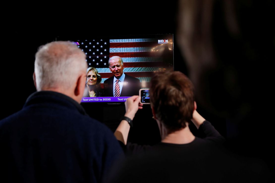 Biden accompanied by his wife Jill speaks to supporters on televised message from South Carolina at his New Hampshire primary night rally in Nashua, New Hampshire 