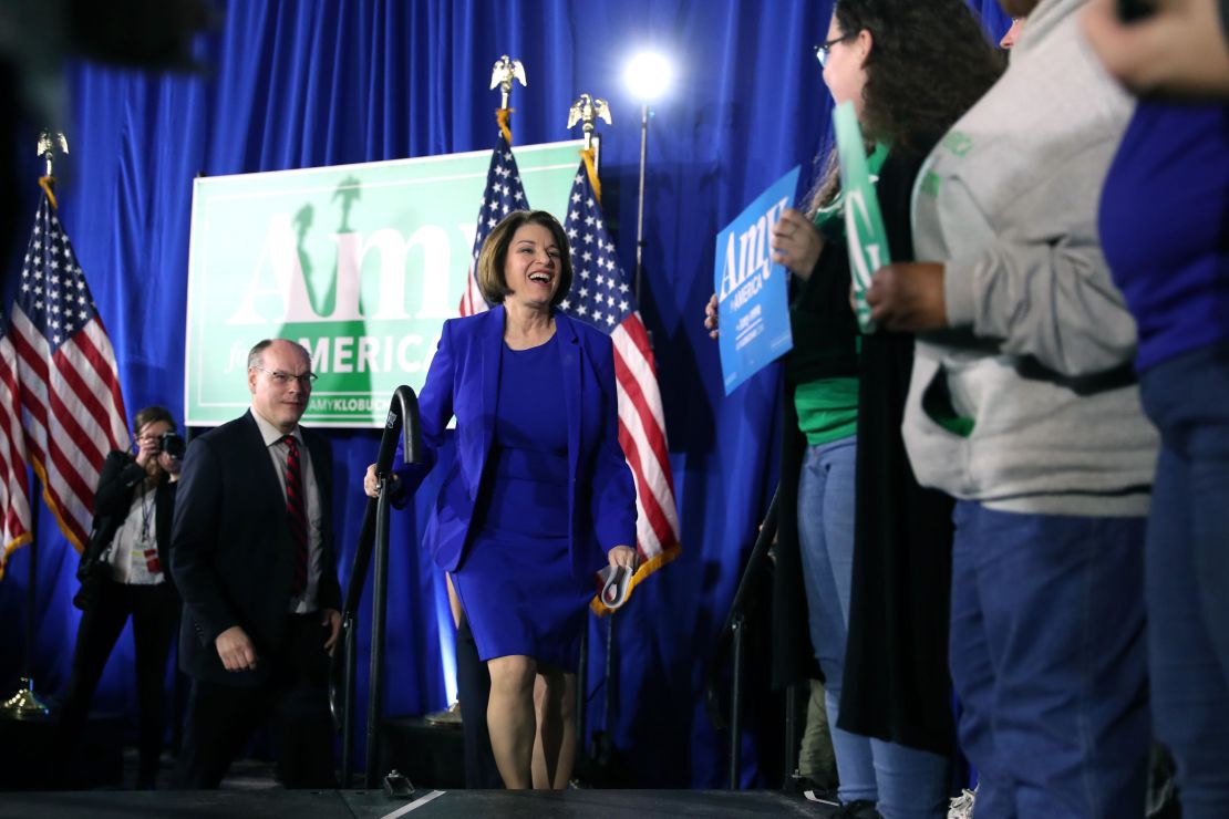 Klobuchar takes the stage with spouse John Bessler during a primary night event at the Grappone Conference Center on February 11, 2020 in Concord, New Hampshire. 