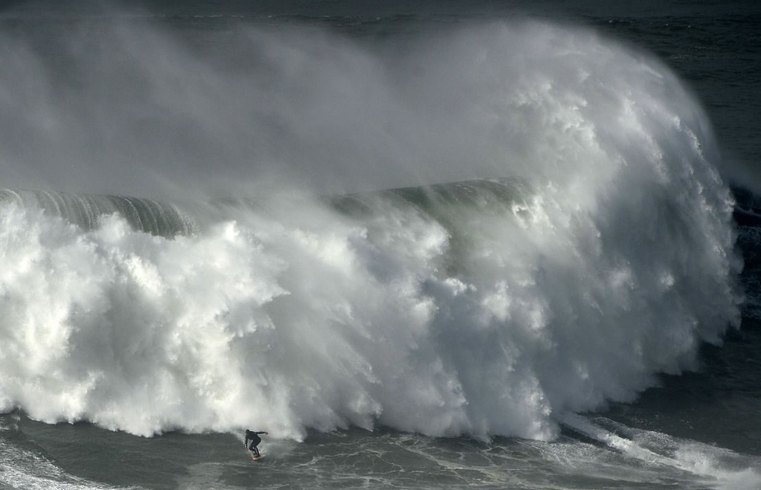 Portuguese surfer Hugo Vau rides a wave during the Nazare Tow Surfing Challenge.