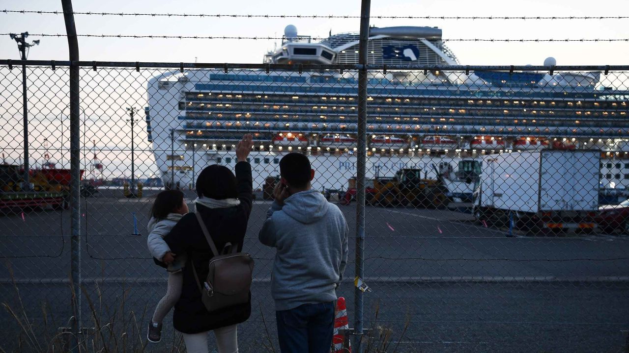 Relatives of passengers wave to the Diamond Princess cruise ship, which has around 3,600 people quarantined onboard due to fears of the new coronavirus.