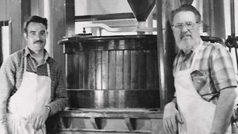 Moore, right, in front of a stone mill in 1979 with Craig Ratzat, one of the first employees at Bob's Red Mill. 