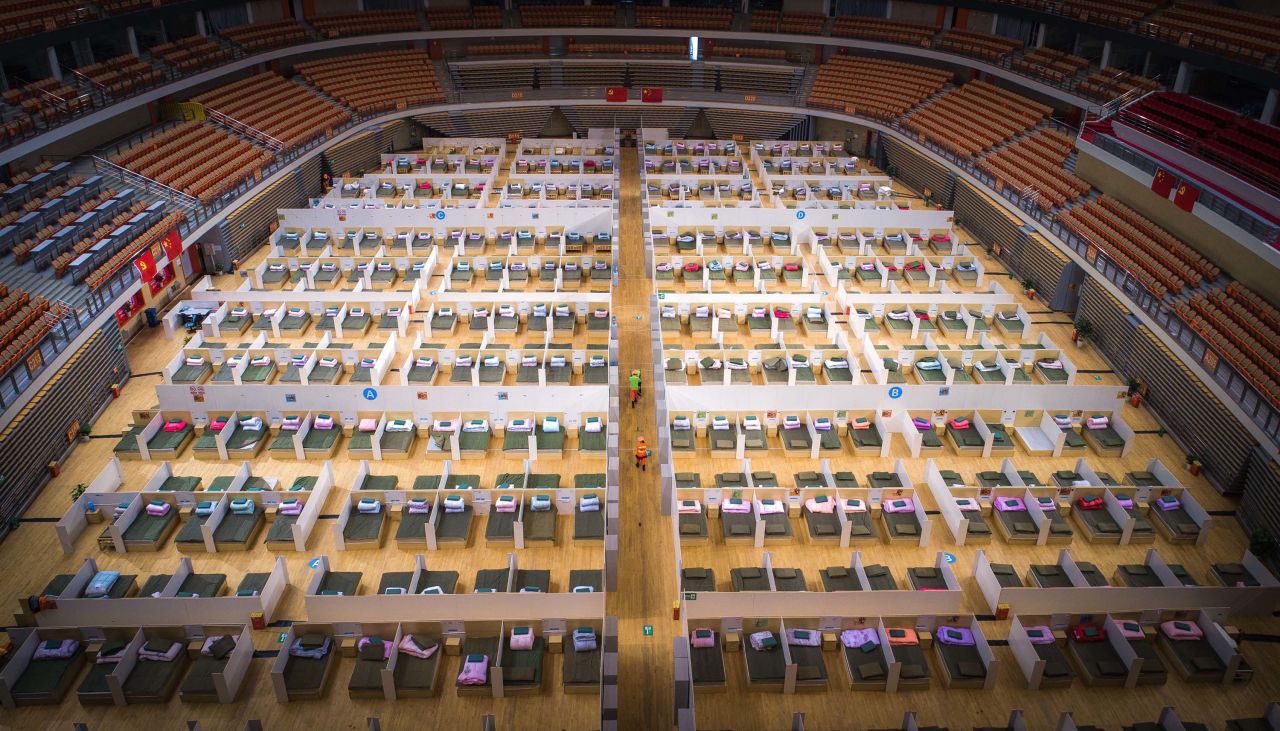 Beds are made in the Wuhan Sports Center, which has been converted into a temporary hospital.