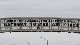 A pedestrian uses a walkway at the main gate at Lackland Air Force Base in San Antonio, Wednesday, Feb. 5, 2020. Several planes carrying U.S. citizens fleeing the virus zone in Wuhan China will arrive at Air Force bases including Joint Base San Antonio-Lackland, where they will be quarantined for up to 14 days, according to the CDC. (AP Photo/Eric Gay)