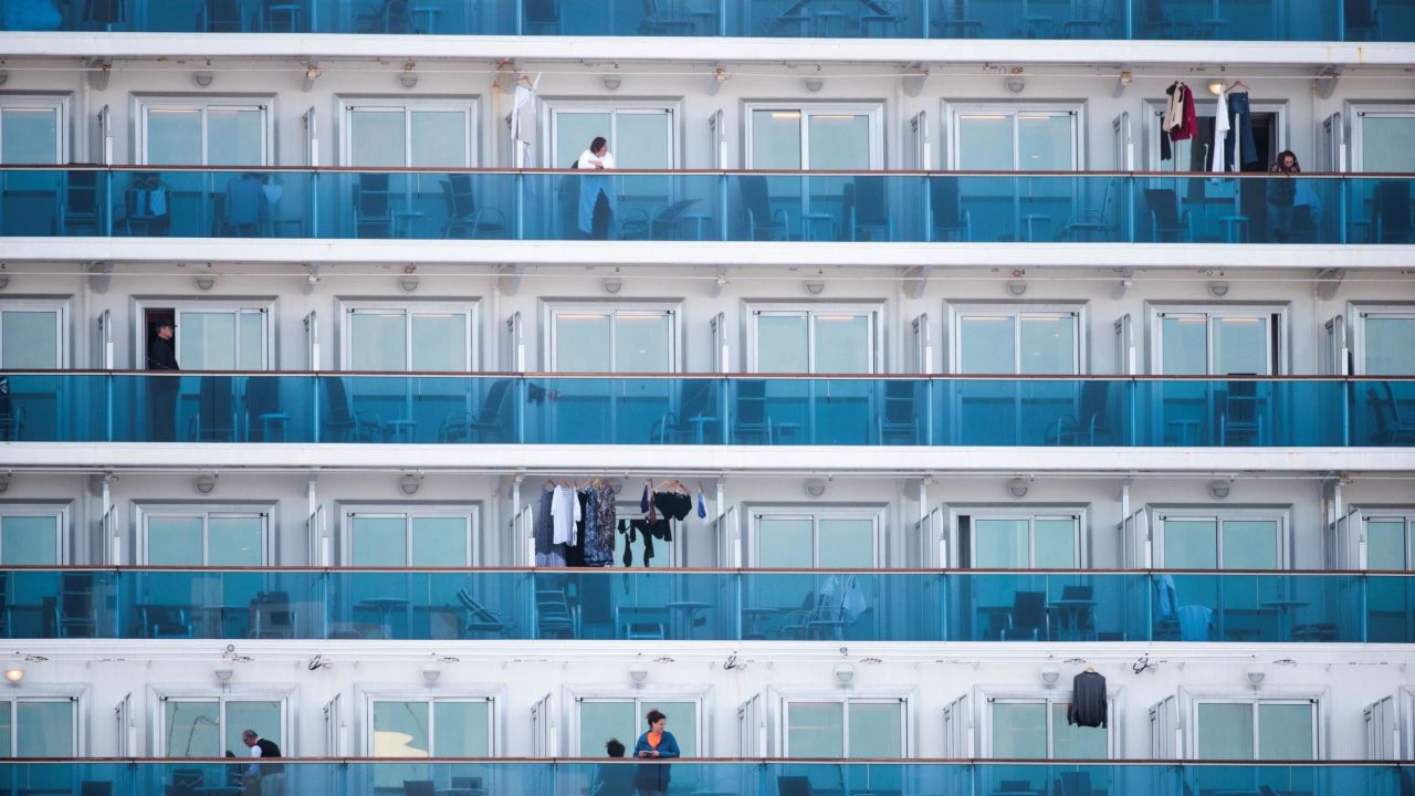 TOPSHOT - Passengers are seen on the balconies of the Diamond Princess cruise ship, with around 3,600 people quarantined onboard due to fears of the new coronavirus, at the Daikaku Pier Cruise Terminal in Yokohama port on February 12, 2020. - A further 39 people on board the Diamond Princess cruise ship off the Japan coast have tested positive for the COVID-19 coronavirus, authorities said on February 12, as thousands more steel themselves for a second week in quarantine. (Photo by Behrouz MEHRI / AFP) (Photo by BEHROUZ MEHRI/AFP via Getty Images)