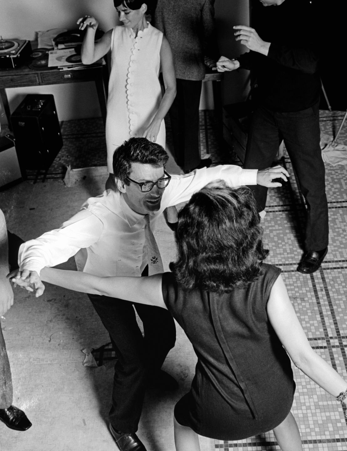 Avedon and China Machado dancing at an after party in Paris in 1965.
