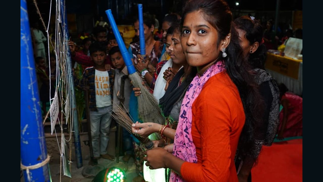 Aarti Shiv cleans an artificial cobweb meant to symbolize taboos and stigma around periods during Maasika Mahotsav in Banjara Basti, India, on May 25, 2019.