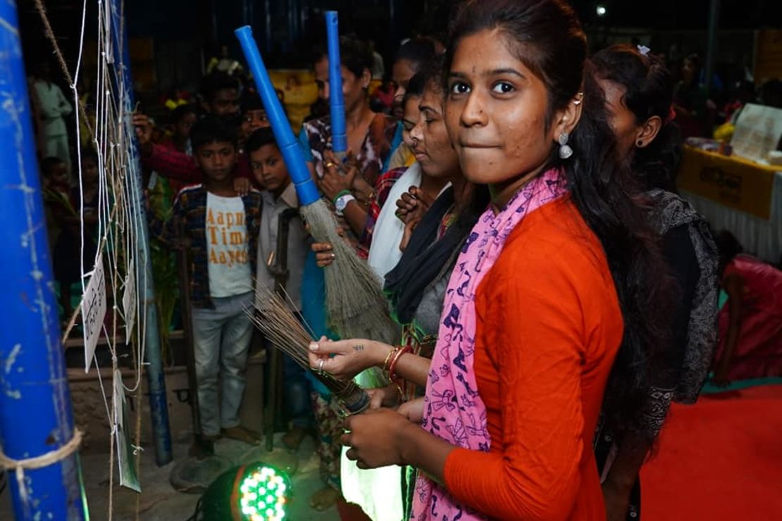 Aarti Shiv cleans an artificial cobweb meant to symbolize taboos and stigma around periods during Maasika Mahotsav in Banjara Basti, India, on May 25, 2019.