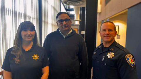Rajbir Singh saved an elderly passenger in his cab from giving a scammer $25,000 in Roseville, California. He is flanked by Roseville Police records clerk Megan Harrigan and police Capt. Josh Simon.