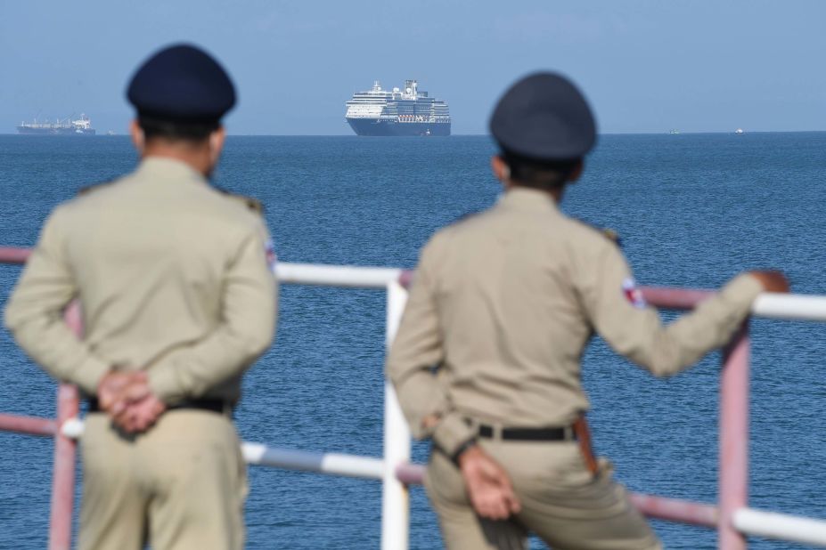 Authorities watch as the Westerdam cruise ship approaches a port in Sihanoukville, Cambodia, on February 13, 2020. Despite having no confirmed cases of coronavirus on board, the Westerdam was refused port by four other Asian countries before being allowed to dock in Cambodia.