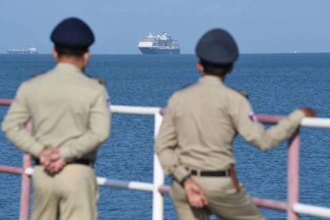 Authorities watch as the Westerdam cruise ship approaches a port in Sihanoukville, Cambodia, on February 13. Despite having no confirmed cases of coronavirus on board, the Westerdam was refused port by four other Asian countries before being allowed to dock in Cambodia.