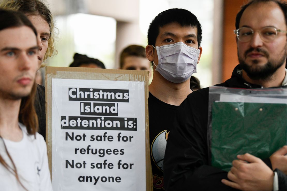 Protesters hold placards during a rally against an inbound travel ban on foreign travellers from China in Sydney on February 7, 2020.