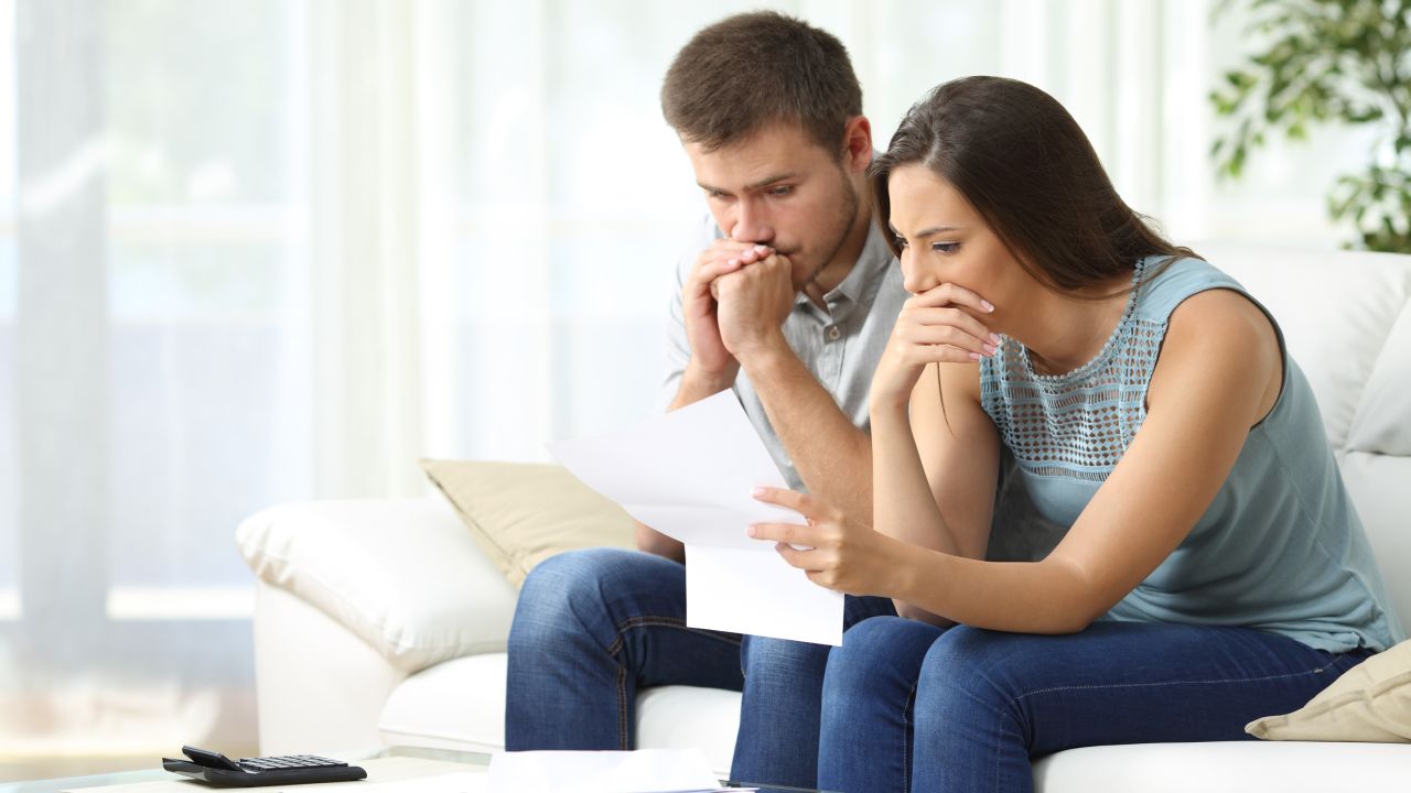 underscored young couple in debt