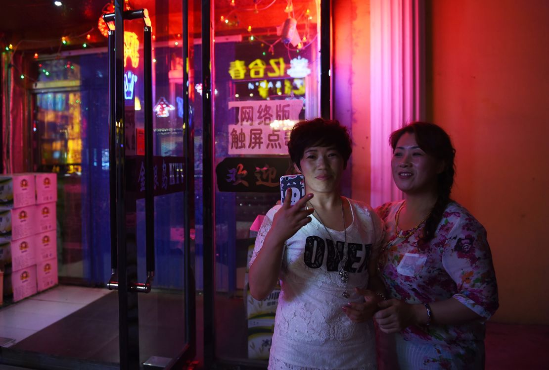 Two women outside a karaoke bar in Hunchun, in China's northeast Jilin province in 2015. 