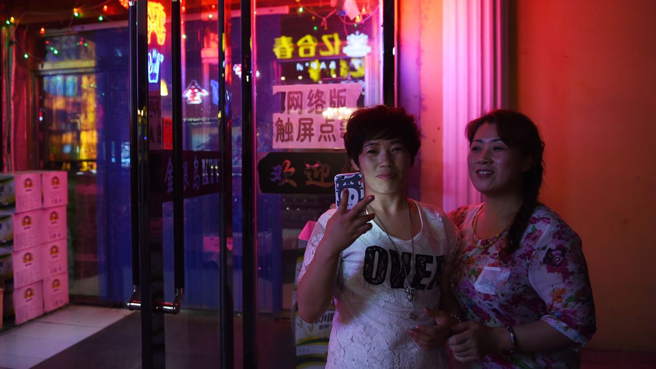 Two women outside a karaoke bar in Hunchun, in China's northeast Jilin province in 2015. 
