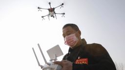 A local resident using a drone sprays disinfectant at a village in Pingdingshan, in China's central Henan province on January 31, 2020, during the virus outbreak in Hubei's city of Wuhan.