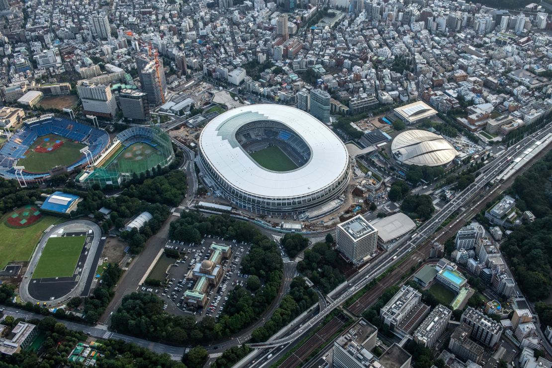 The New National Stadium, the main stadium for the Tokyo 2020 Olympics, and the Tokyo Metropolitan Gymnasium (C-R) are pictured on July 24, 2019 in Tokyo, Japan.