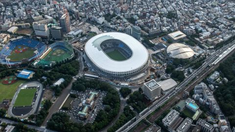 The New National Stadium, the main stadium for the Tokyo 2020 Olympics, and the Tokyo Metropolitan Gymnasium (C-R) are pictured on July 24, 2019 in Tokyo, Japan.