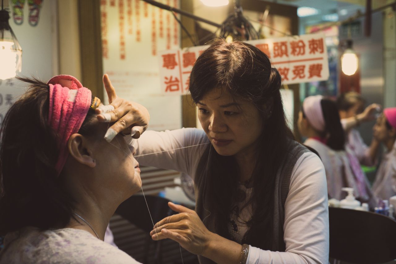 Threading -- which removes facial hair -- has long been a traditional beauty procedure, as seen in this picture at a Taipei night market. A thin thread is doubled, then twisted and rolled over areas of unwanted hair, plucking the hair at the follicle level. 