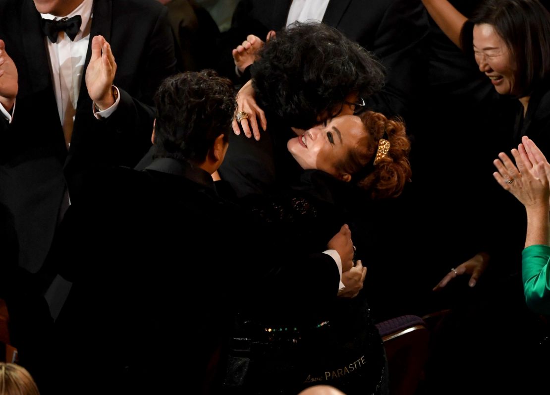 Bong Joon-ho and Miky Lee hug after 'Parasite' was named winner of the Best Picture award during the 92nd Annual Academy Awards on February 9, 2020 in Hollywood, California.