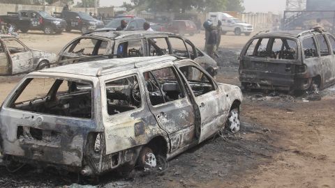 Cars burnt by suspected militants in the attack.