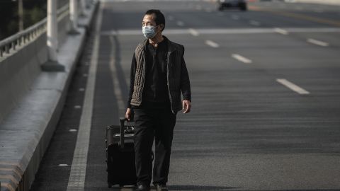 A man wears a protective mask as he walks in Wuhan on February 13, 2020.