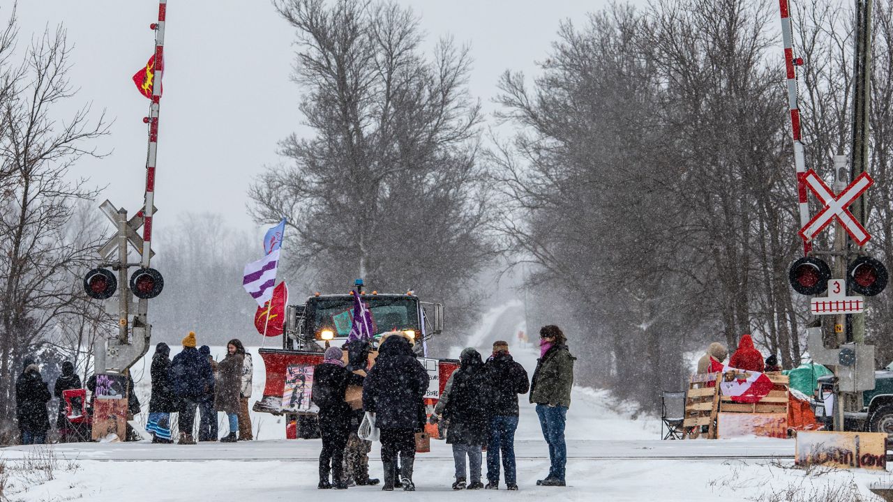 Demonstrators stand near railway tracks during a protest near Belleville, Ontario, on Thursday.