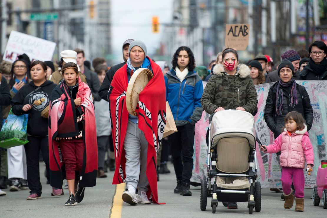 People demonstrating in solidarity with the Wet'suwet'en Nation walk in downtown Vancouver, British Columbia, on Wednesday,