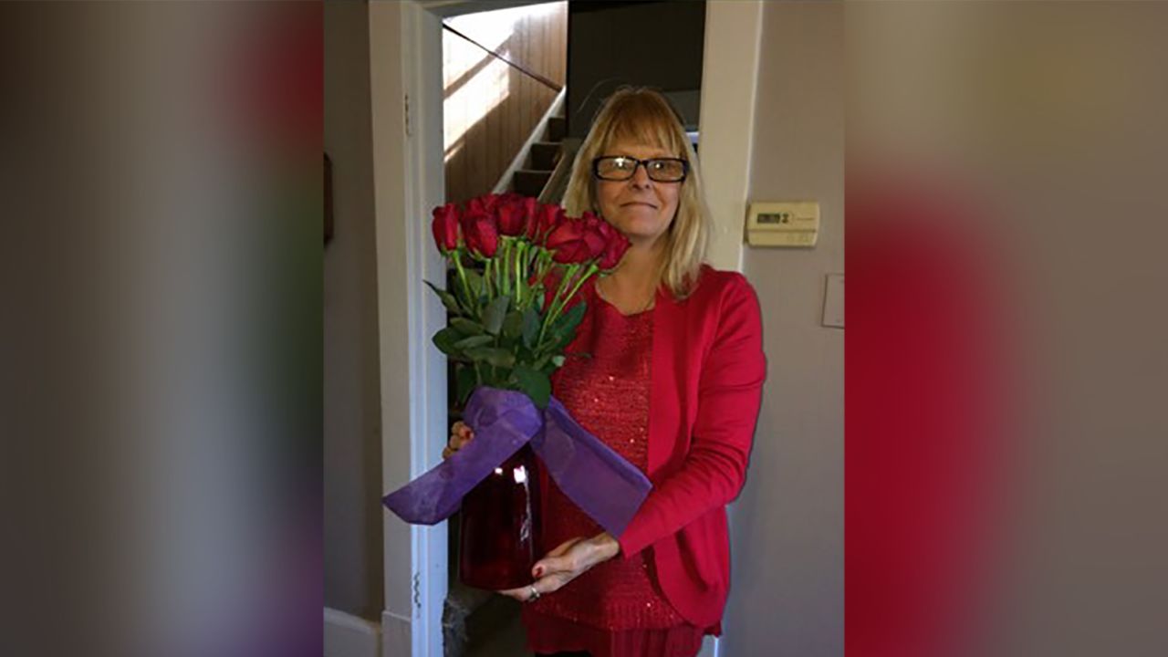 Tracey with Rich's flower arrangement from 2016.
