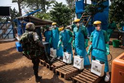 A UN peacekeeper has his shoes cleaned with a chlorine solution before leaving an Ebola treatment center in Mangina, North Kivu province, DRC, on September 1, 2019.