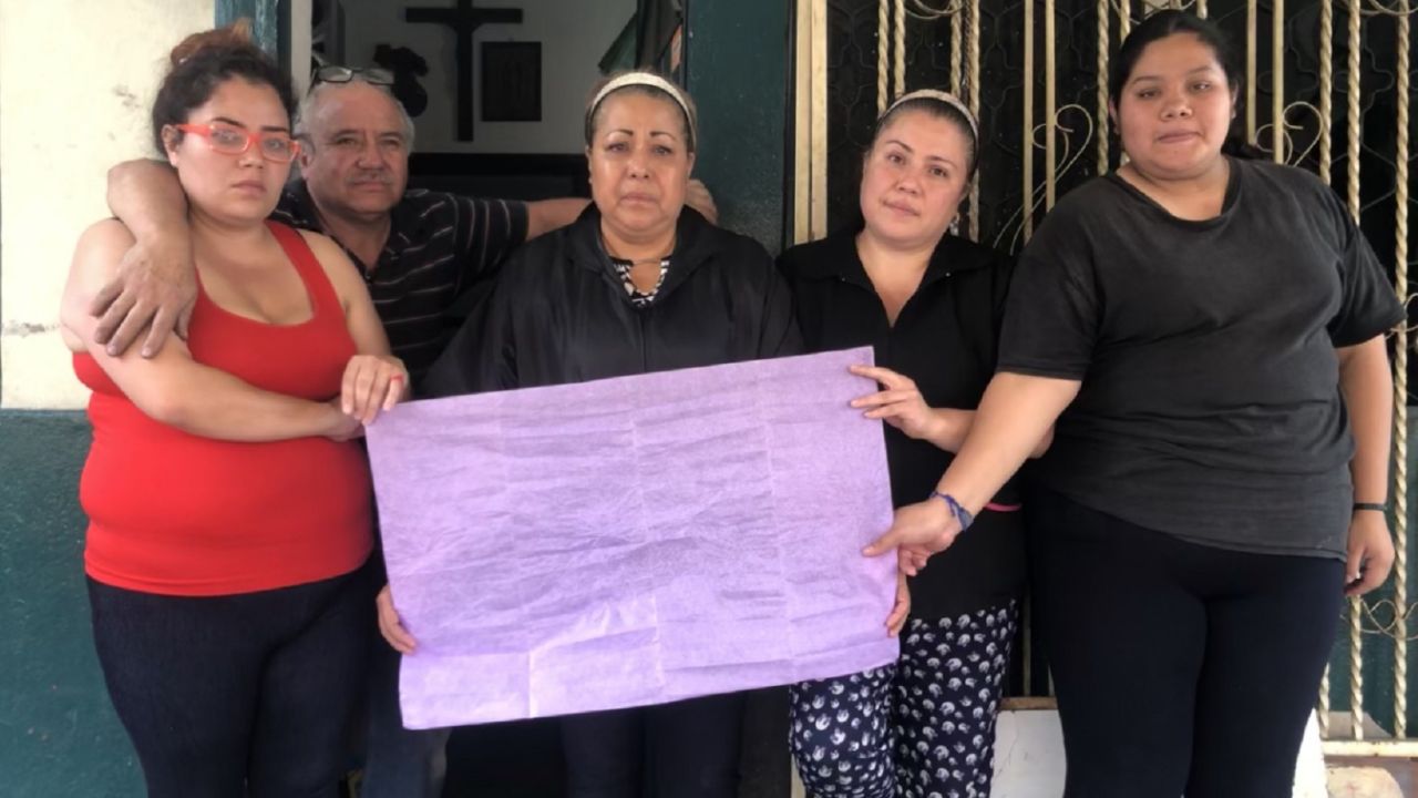 Nitzi Gonzalez and her family hold up purple tissue paper in support of victims of femicide.