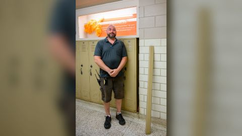 Pyle stands next to the wall where he found the purse.