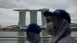 SINGAPORE - 2020/02/12: People wearing protective surgical masks towards the Merlion Park, a major tourist attraction in Singapore.Singapore declared the Coronavirus outbreak alert as Code Orange on February 7, 2020. (Photo by Maverick Asio/SOPA Images/LightRocket via Getty Images)