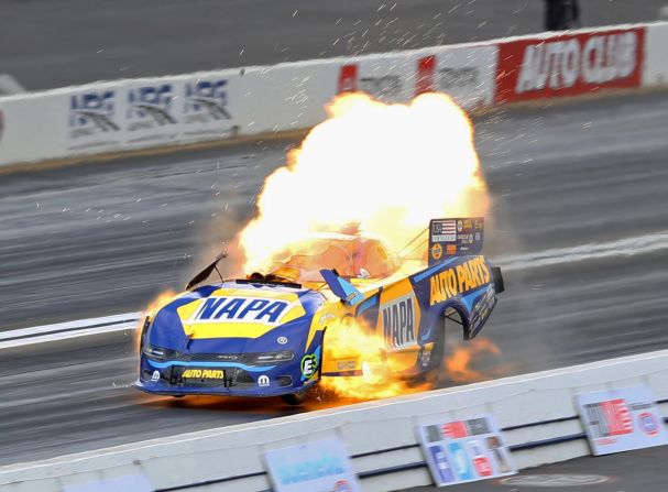 An NHRA Funny Car driven by Ron Capps explodes during the Winternationals at Auto Club Raceway in Pomona, California, on Sunday, February 9. Capps was unhurt in the accident.