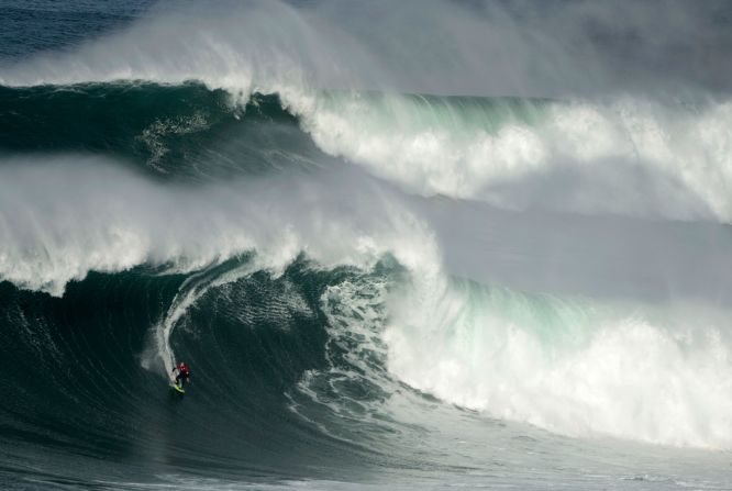 A surfer rides a big wave at the Praia do Norte in Nazare, Portugal, on February 15.